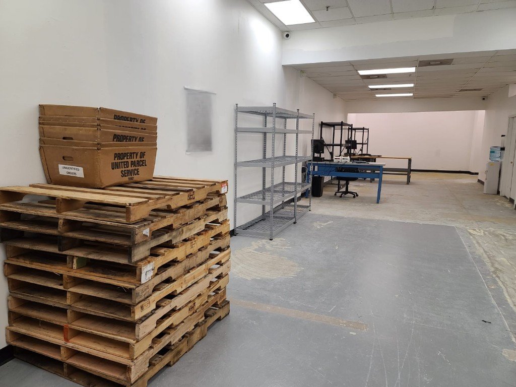 Warehouse floor with pallets and shelving